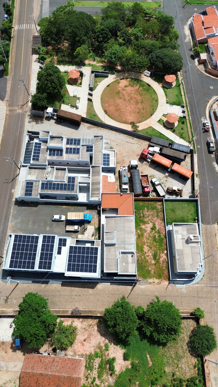 services-02 Aerial city view highlighting solar panels and green spaces on a sunny day.